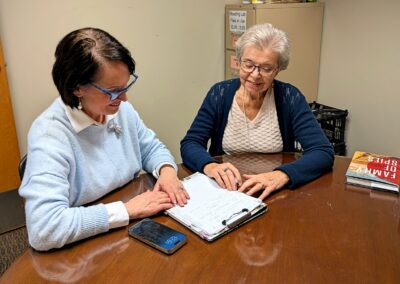 Female student with older female volunteer sitting at a table