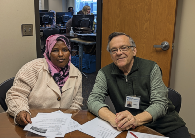 Male Volunteer with student at table